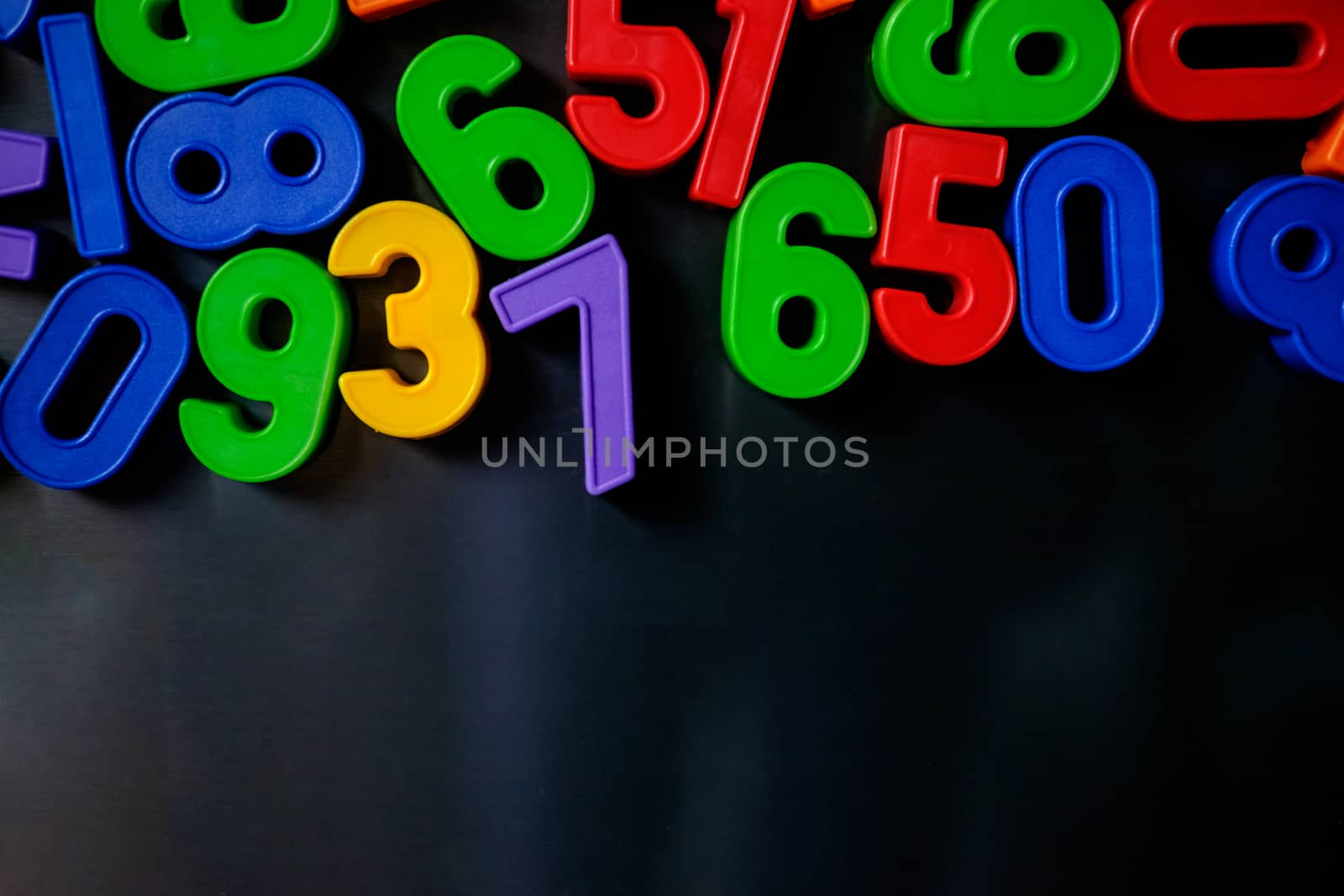 Colorful magnetic numbers and letters on the fridge by mikelju
