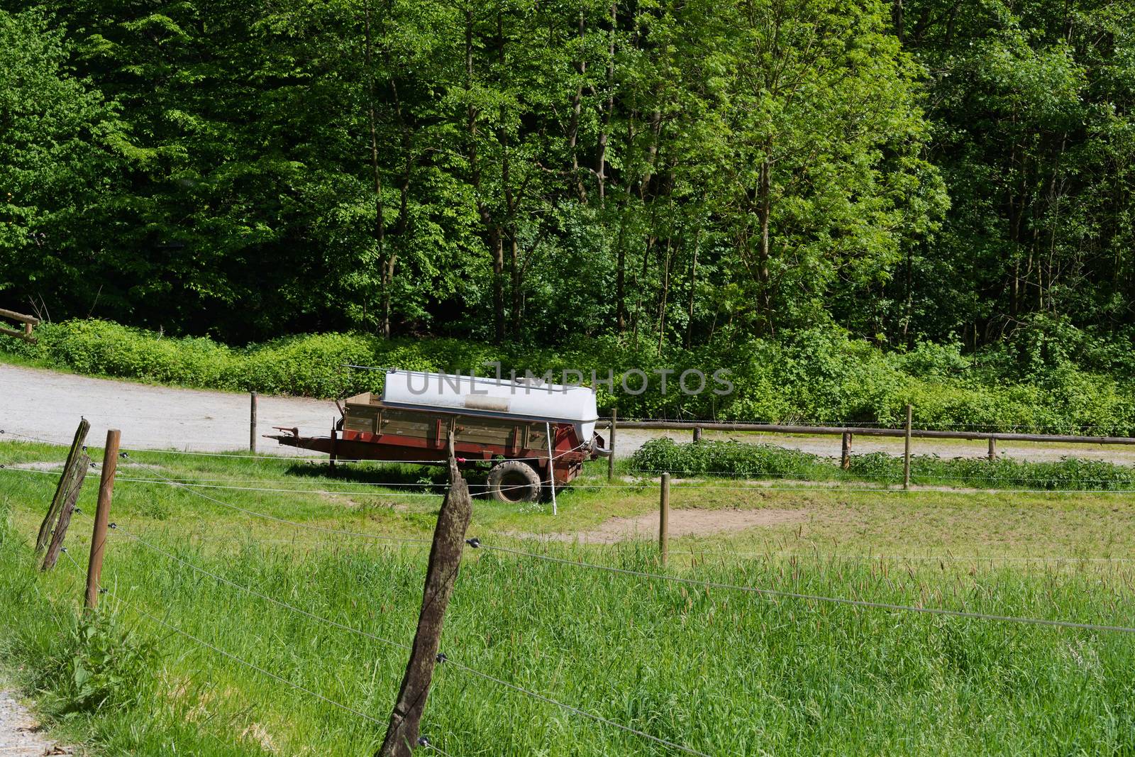 Old abandoned rusty car trailer tank as cattle-drinking