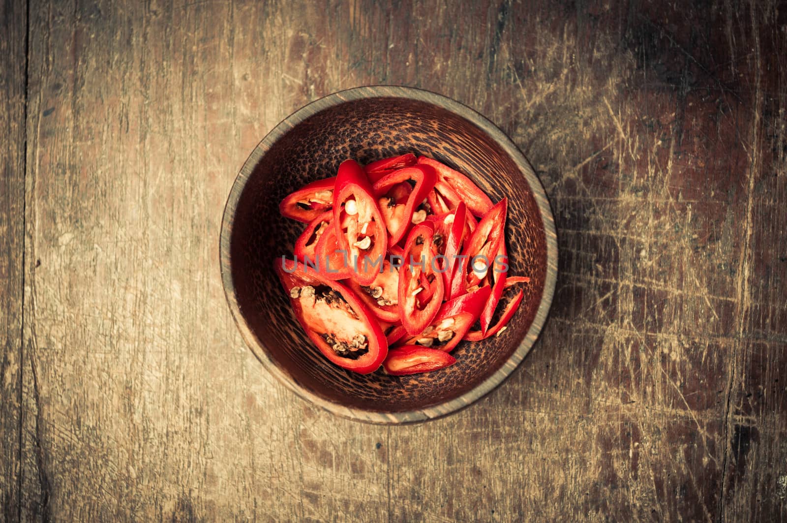Chili slice in wood bow on wooden