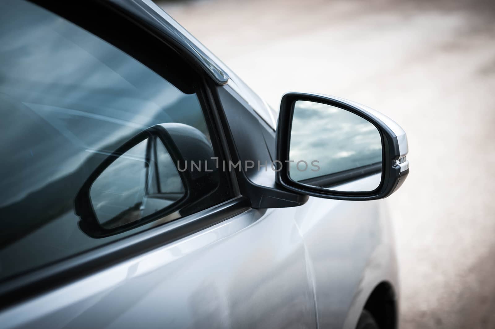 Closeup side of car door mirror glass