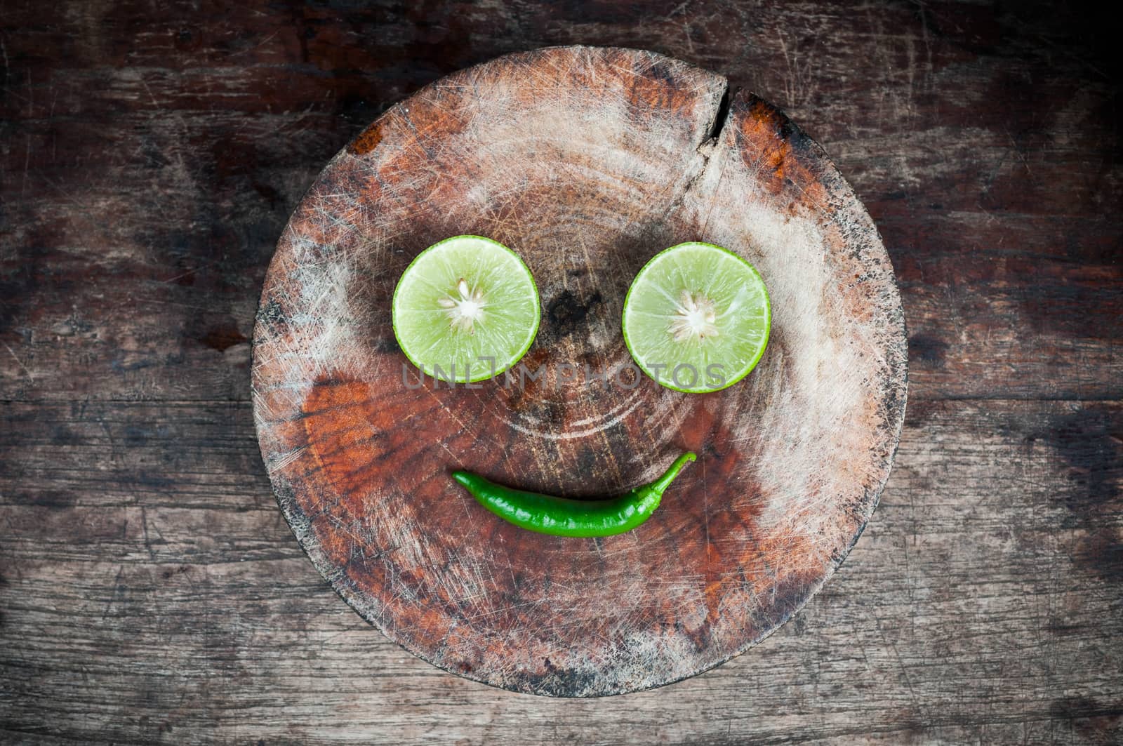 Green Lemon cut on wood block