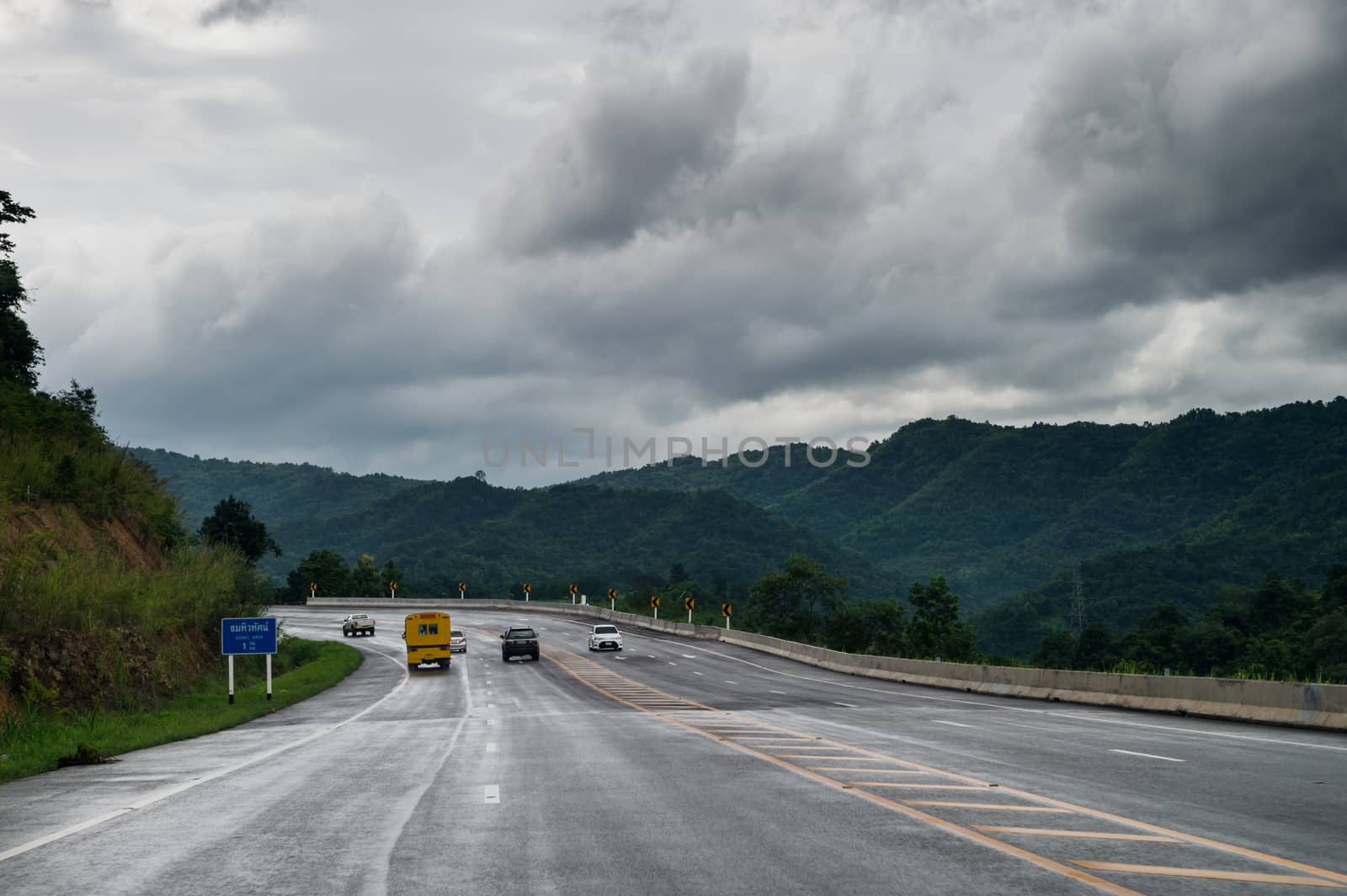 road on mountain with clouds sky