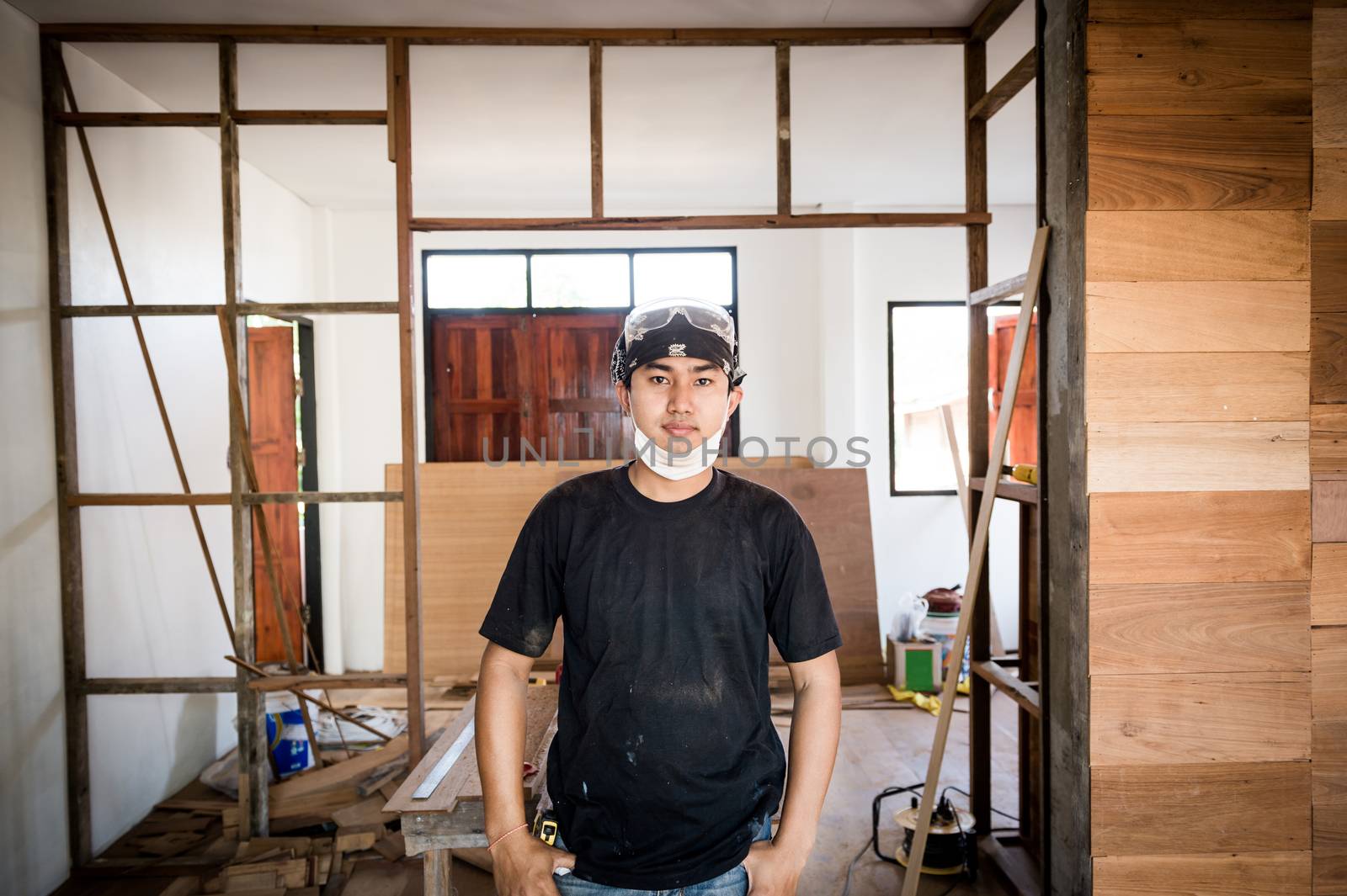Young male carpenter portrait in workshop interior by sayhmog