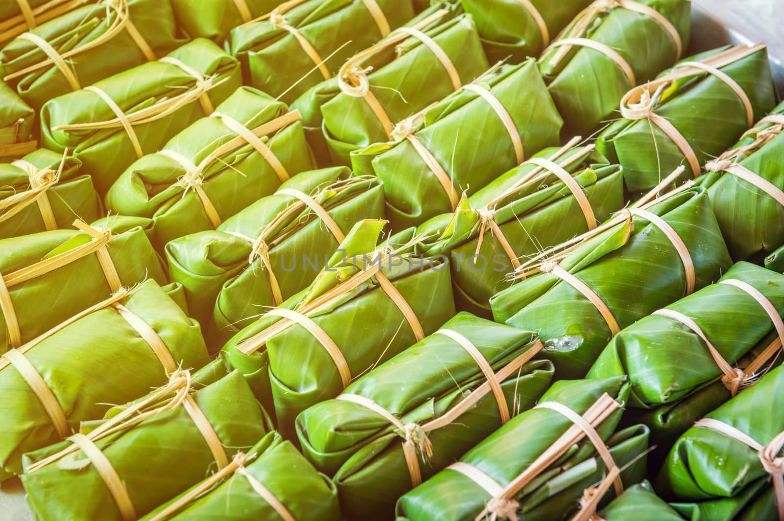Green background of Khao Tom Mad, dessert food of Thailand culture