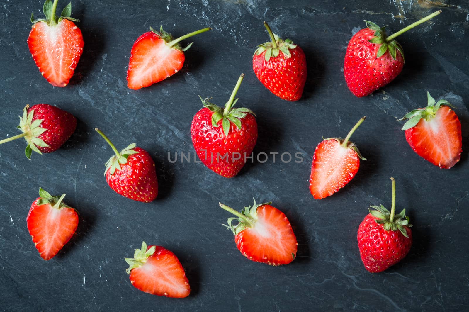 Strawberry fruit on black stone background