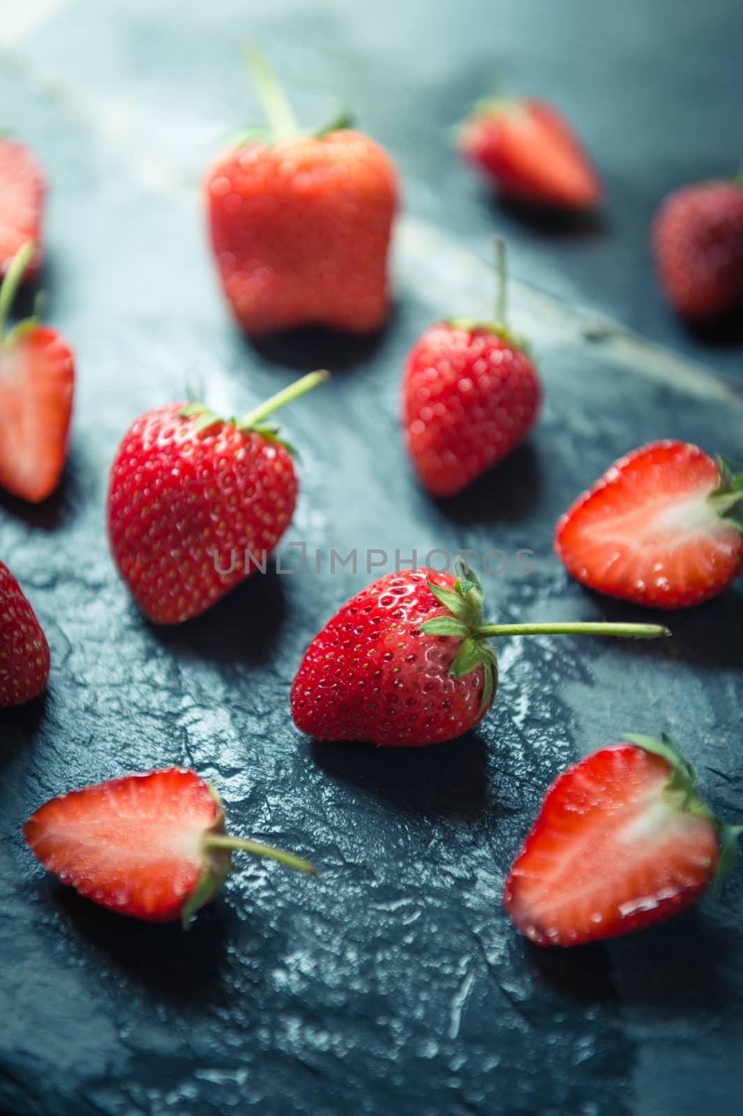 closeup of Strawberry fruit on black stone background