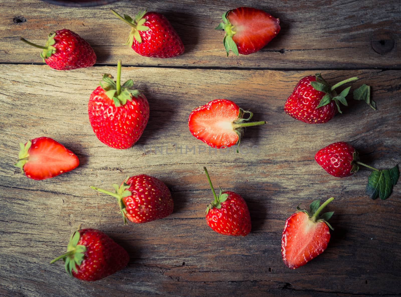 closeup of strawberry fruit on grunge wooden background