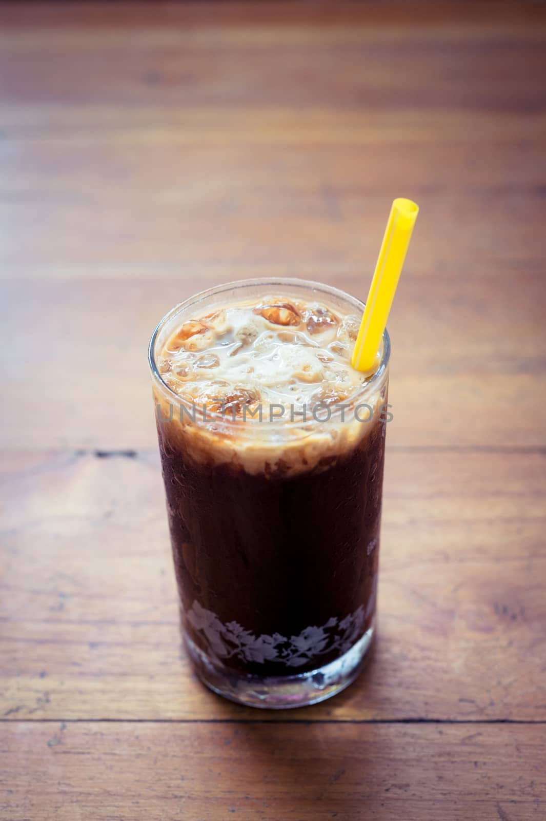 Ice coffee on wooden background