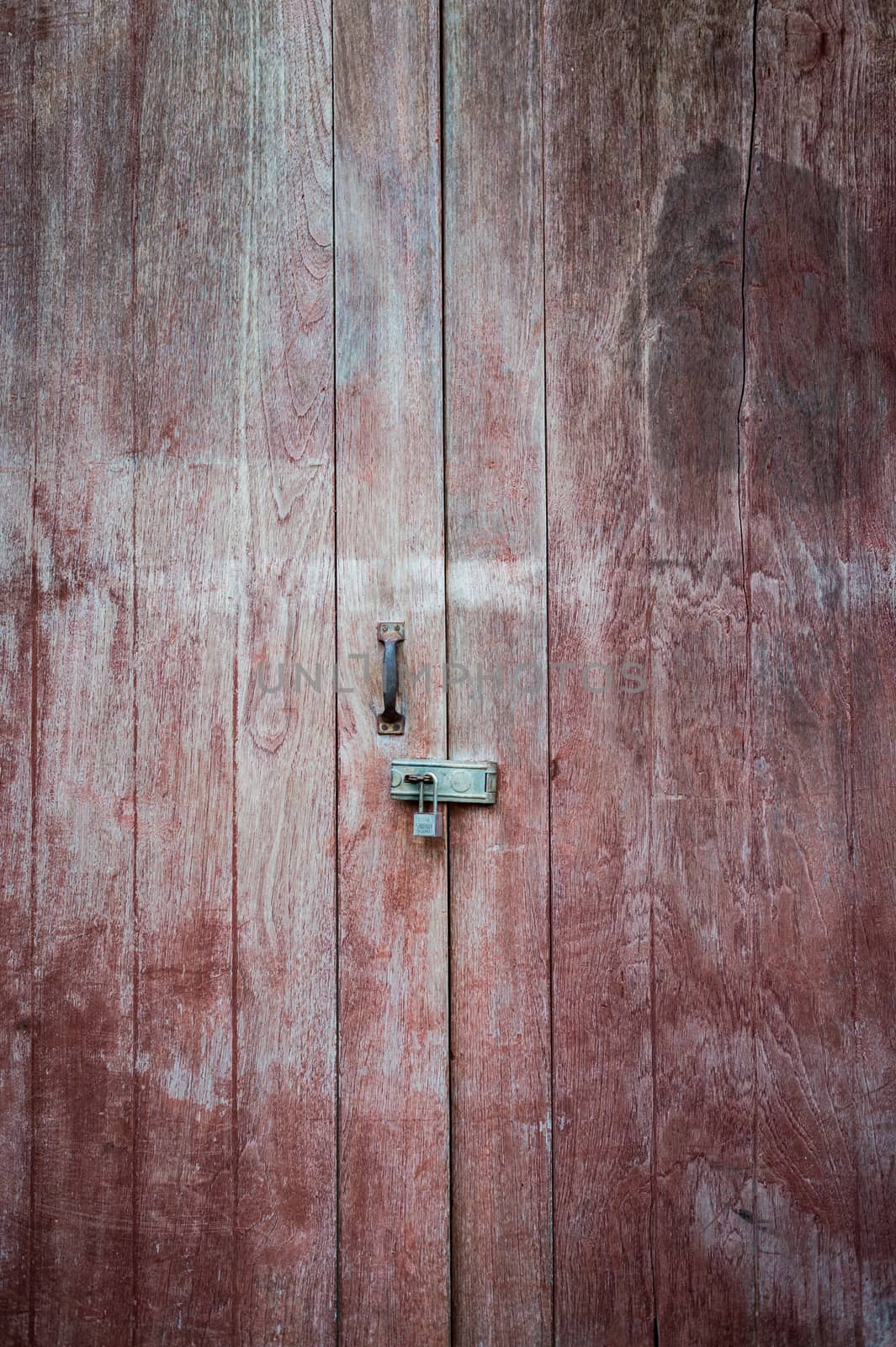 Closeup of old key lock with wood door