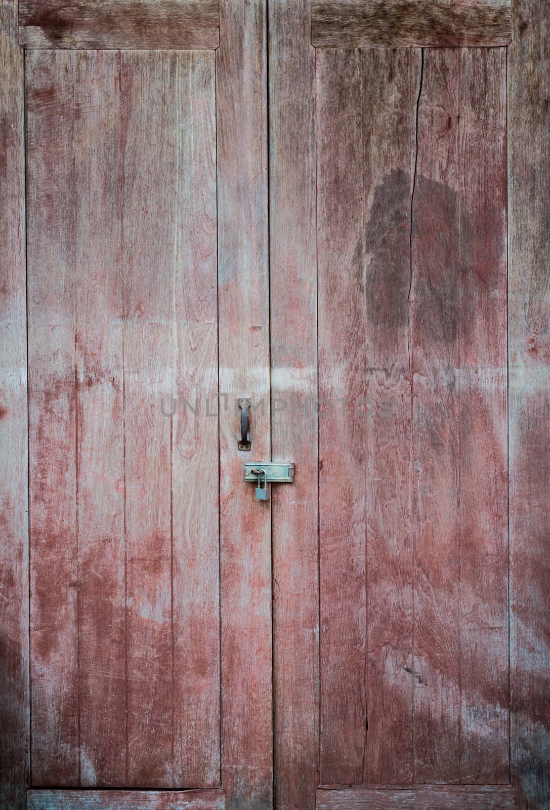 Closeup of old key lock with wood door