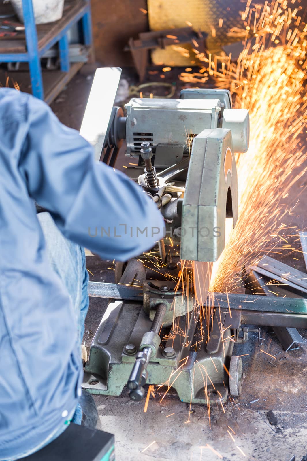 Worker Cutting of Steel in workshop