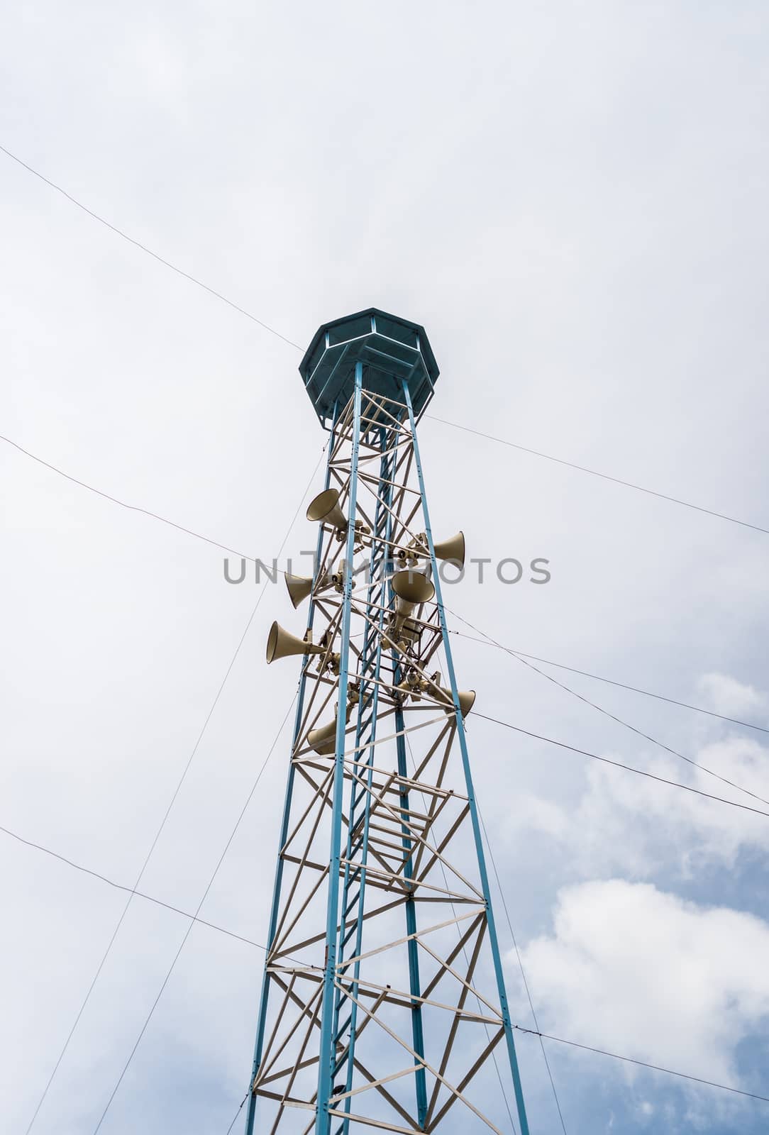 Loudspeaker tower and clouds sky