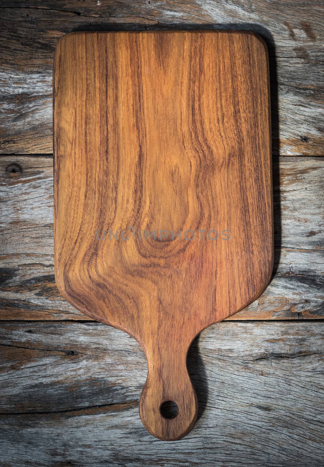 Chopping board on wooden plank background