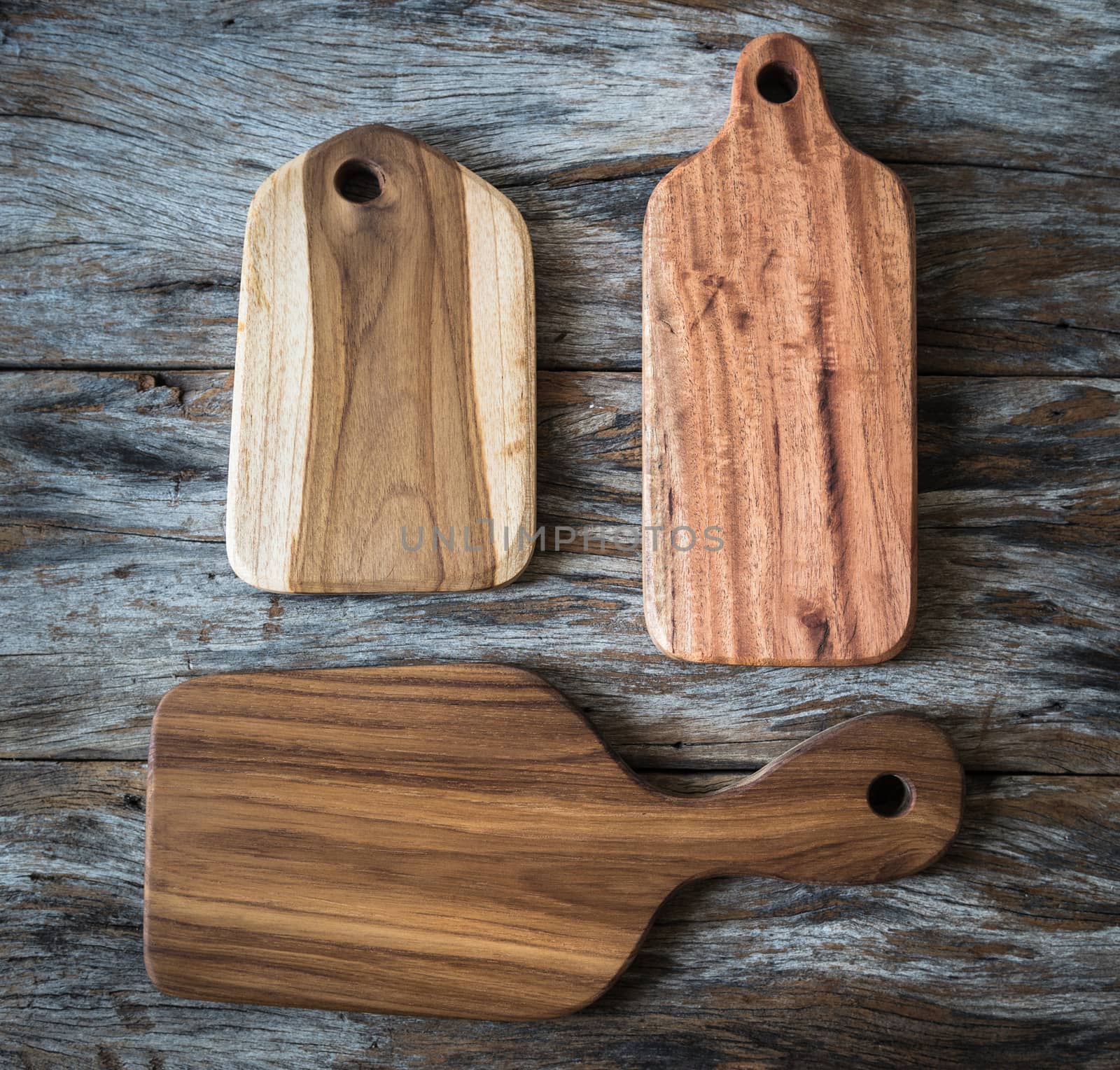 Chopping board on wooden plank background