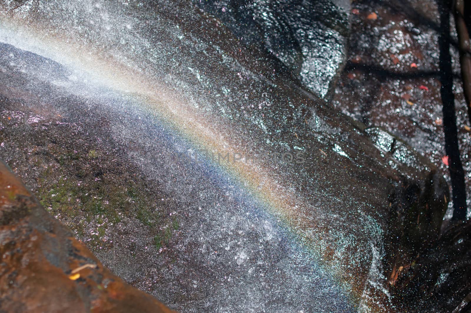 Closeup of rainbow on waterfall by sayhmog