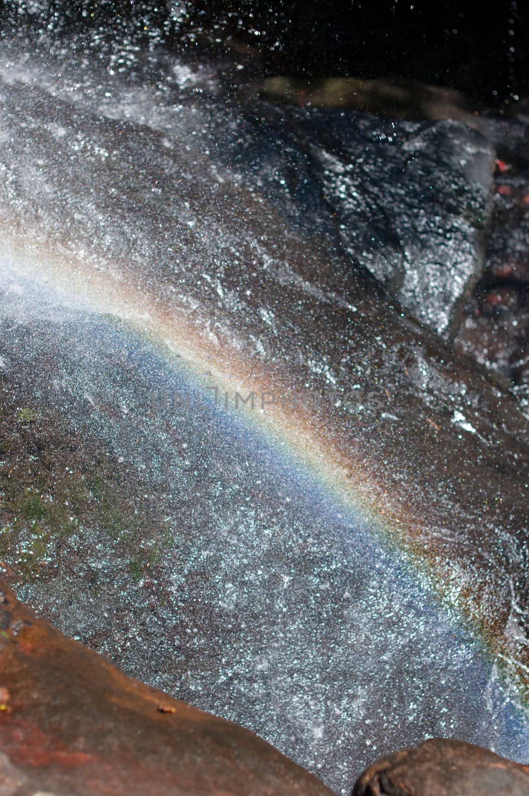 Closeup of rainbow on waterfall by sayhmog