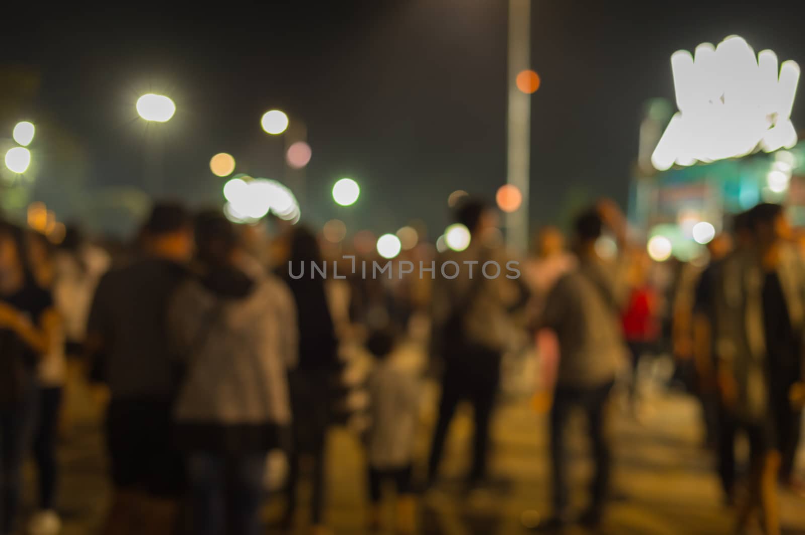 Blurred of people walk in night market
