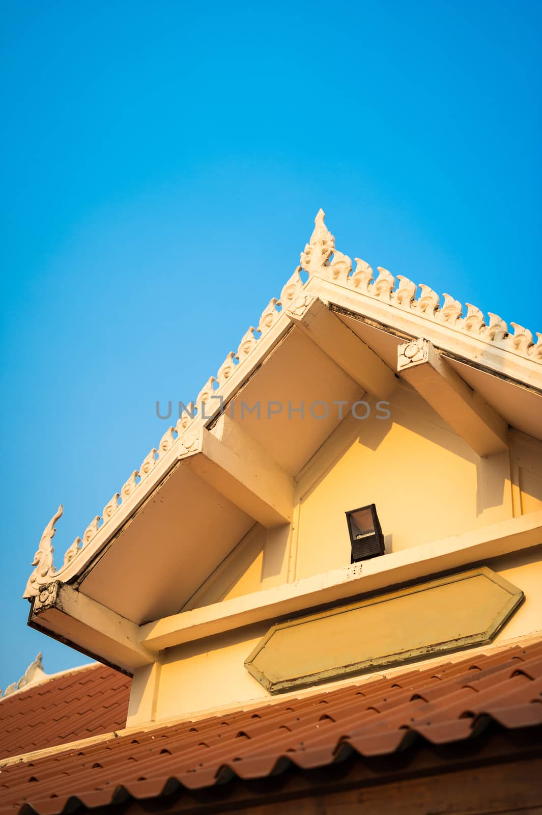 Closeup of gable temple with blue sky by sayhmog