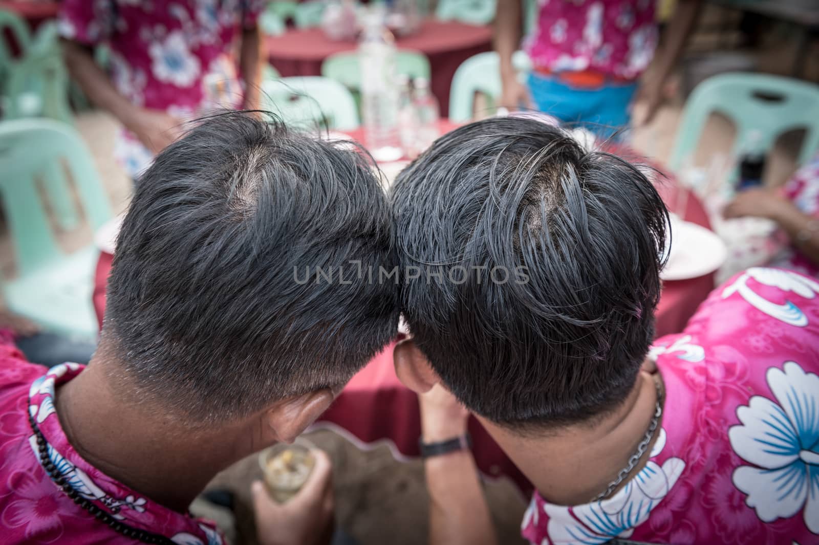 Closeup of two human head collide with each other to see something