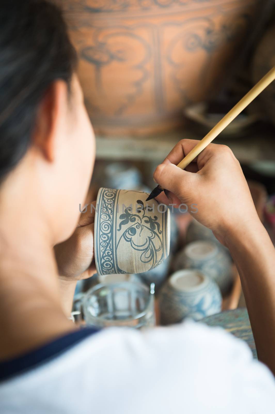 Closeup of people made painting on ceramic cup