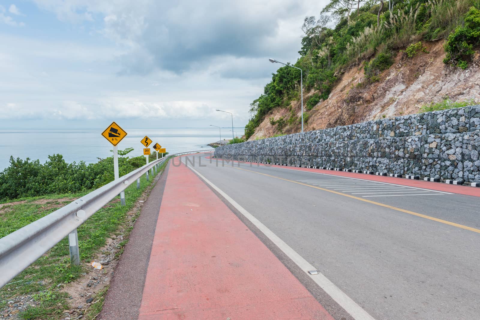 Lane of asphalt road with the ocean landscape