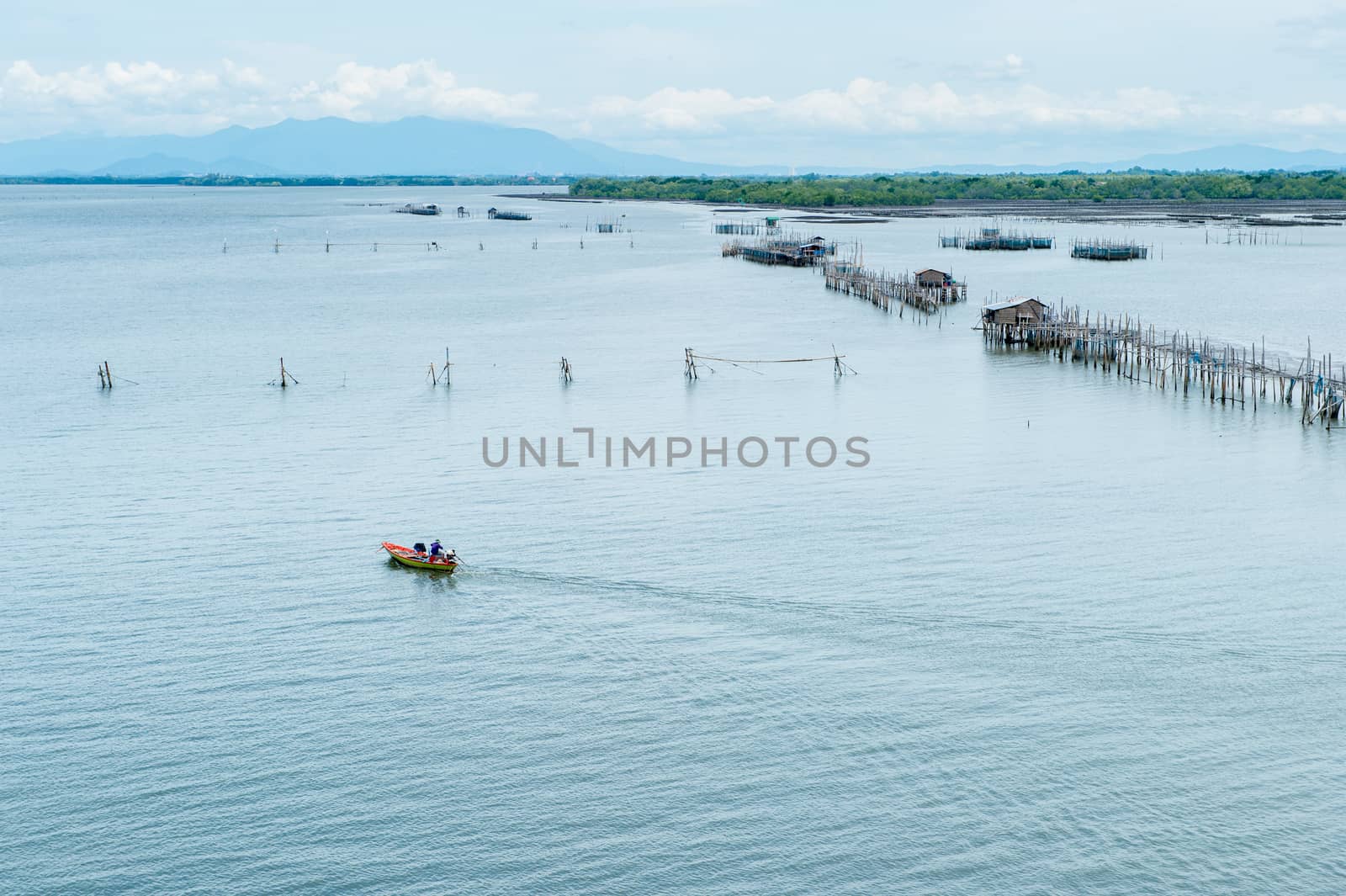 Boat running on the sea with fisherman's farm