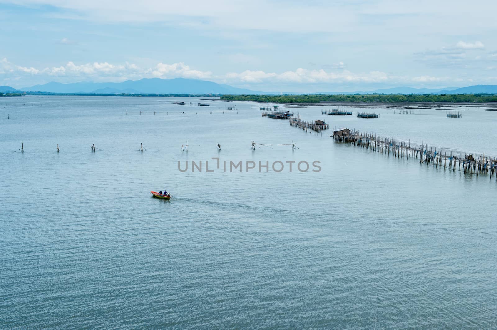 Boat running on the sea with fisherman's farm