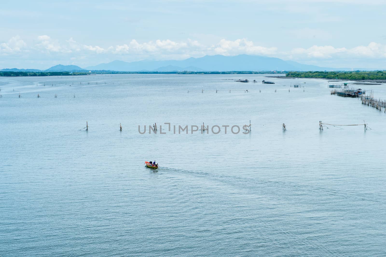 Boat running on the sea with fisherman's farm by sayhmog