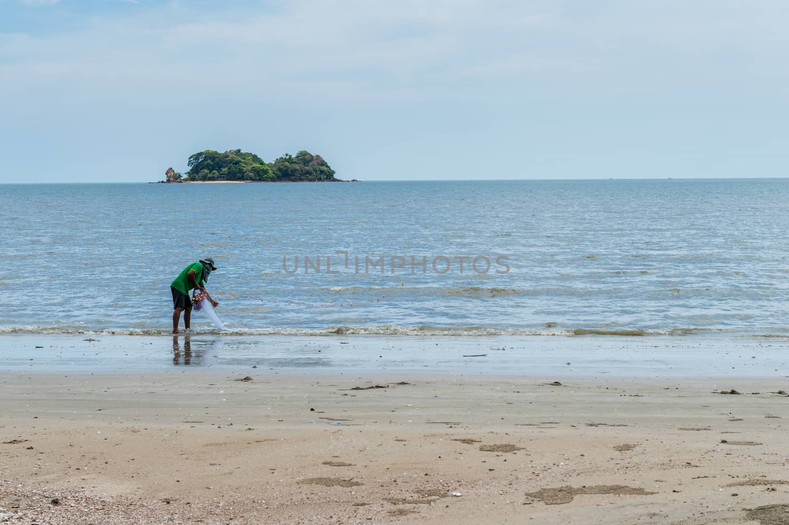 Fisherman with him job on the beach by sayhmog