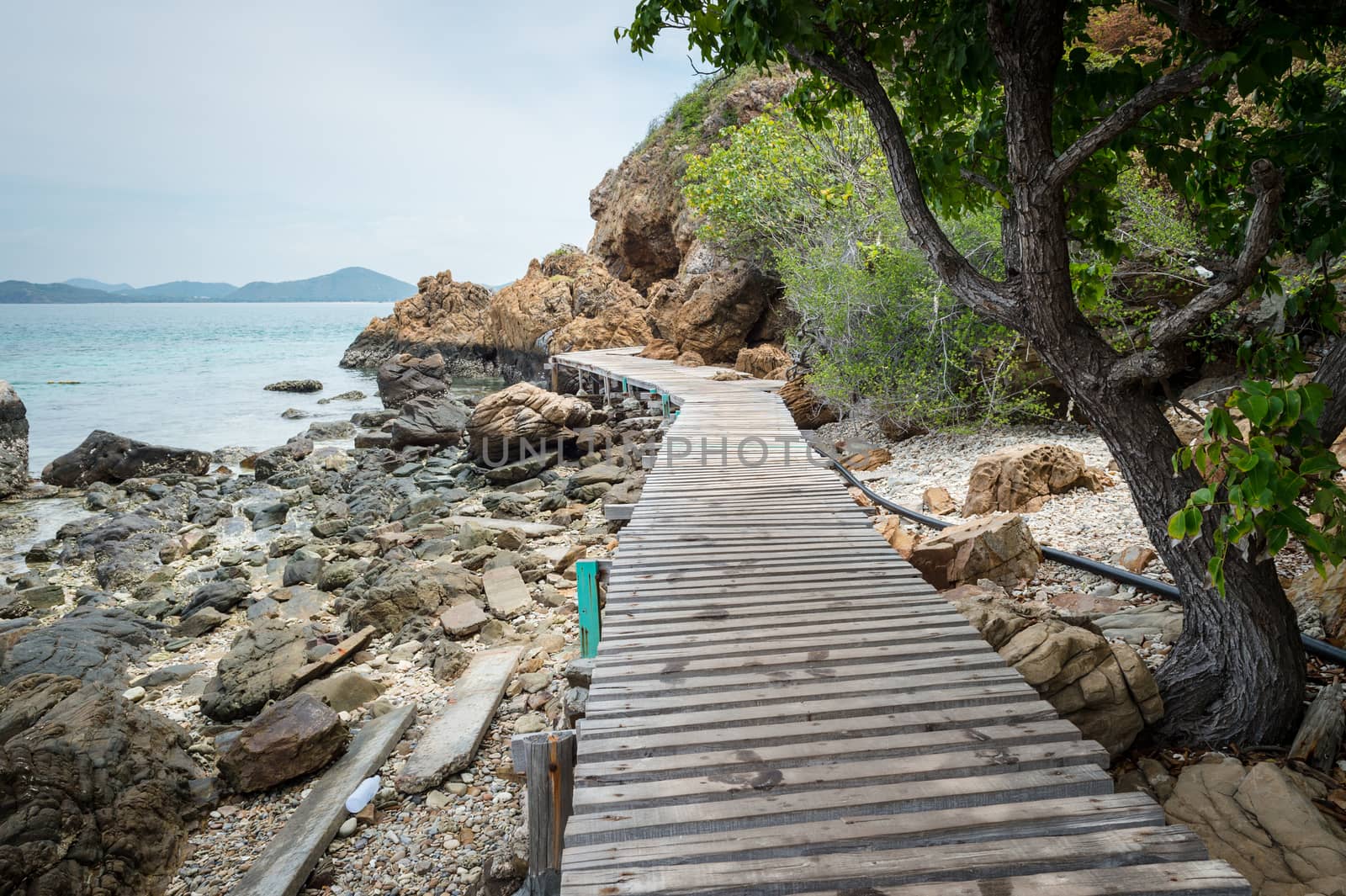 Wooden pathway with rock valley or cliff on the island by sayhmog