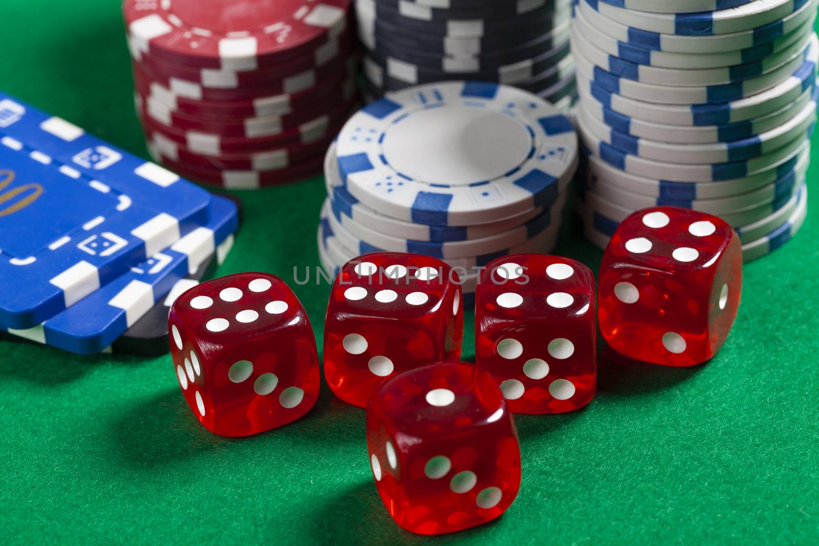 Red Dice and Casino Chips on Green Poker Table
