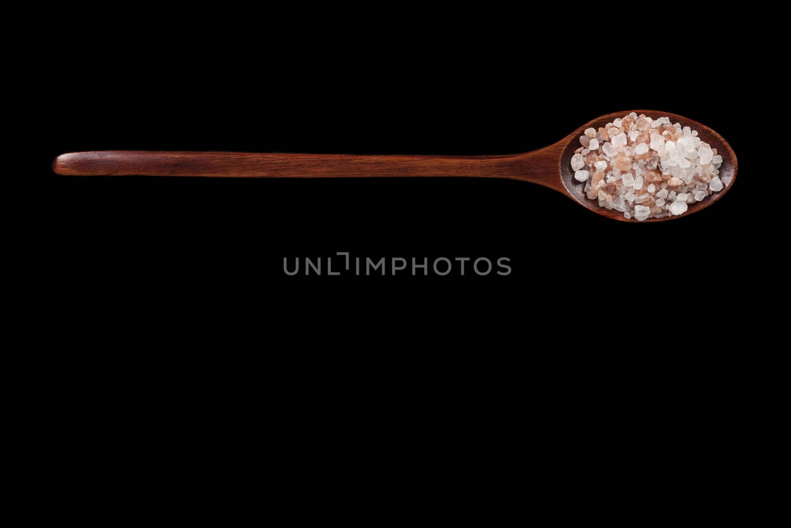 Wood Spoon Full With Himalayan Salt on Black Background