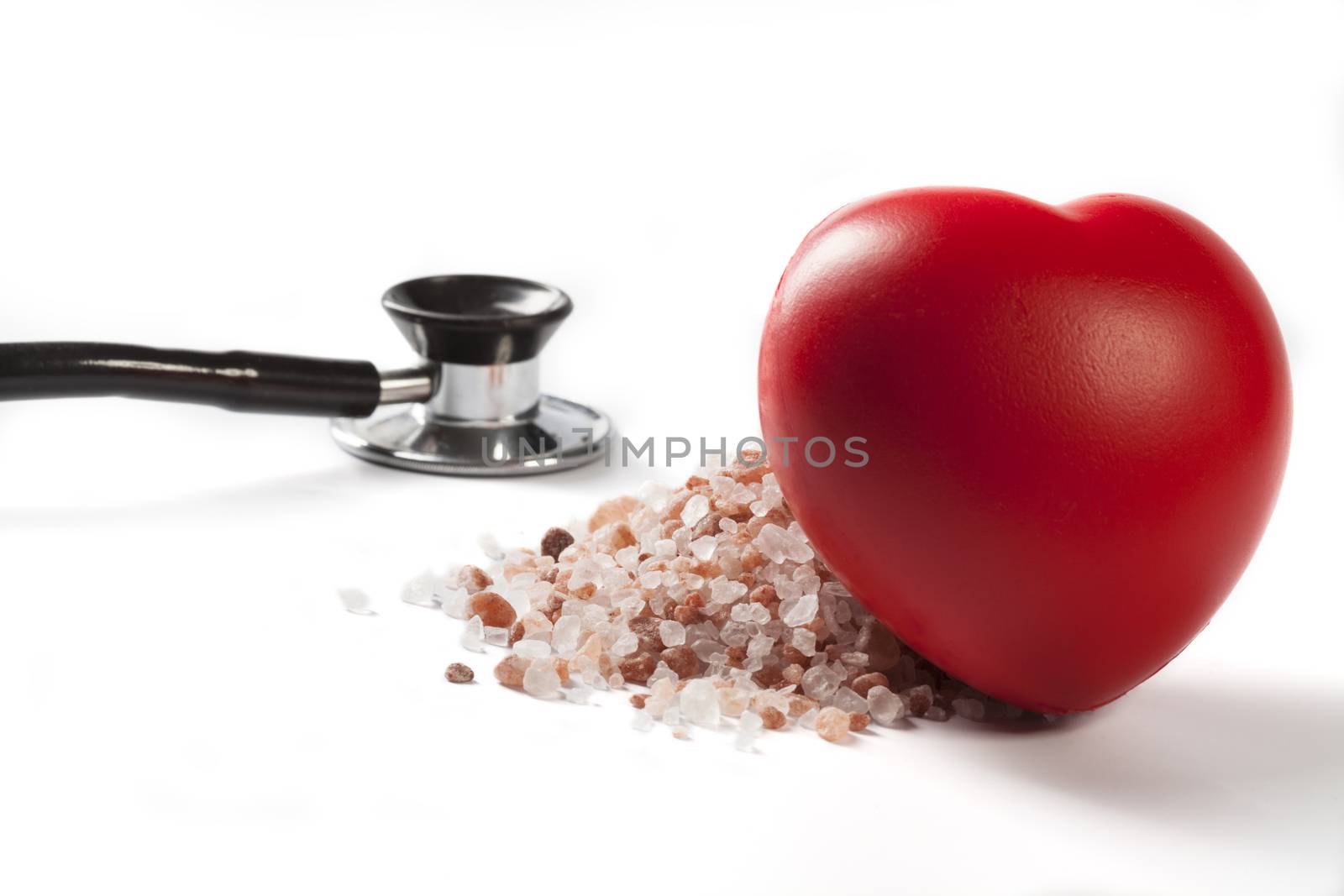 Himalayan Salt Raw Crystals With Red Heart and Black Stethoscope Isolated on White Background