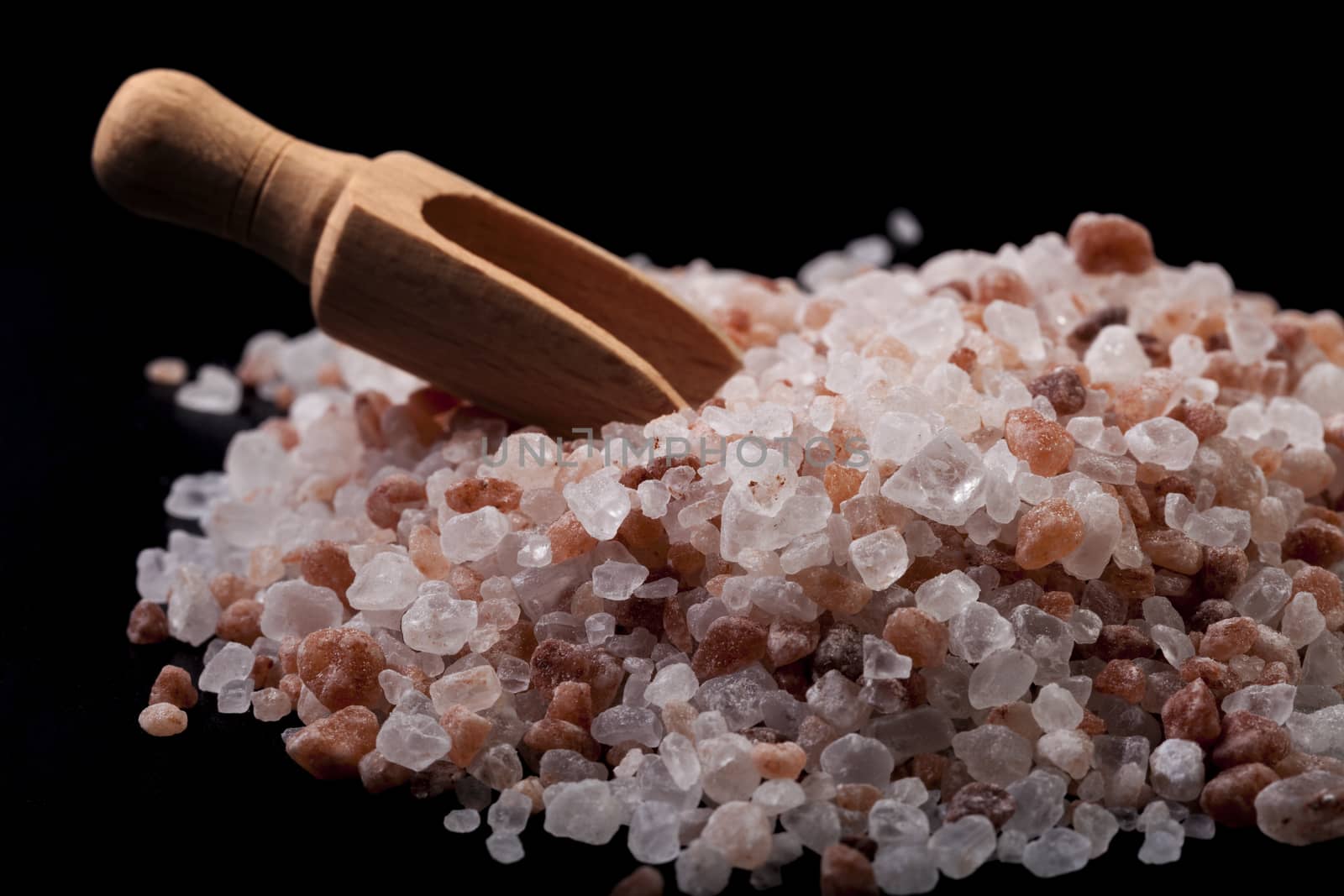 Himalayan Salt Close-up With Brown Wood Spice Spoon On Black Background