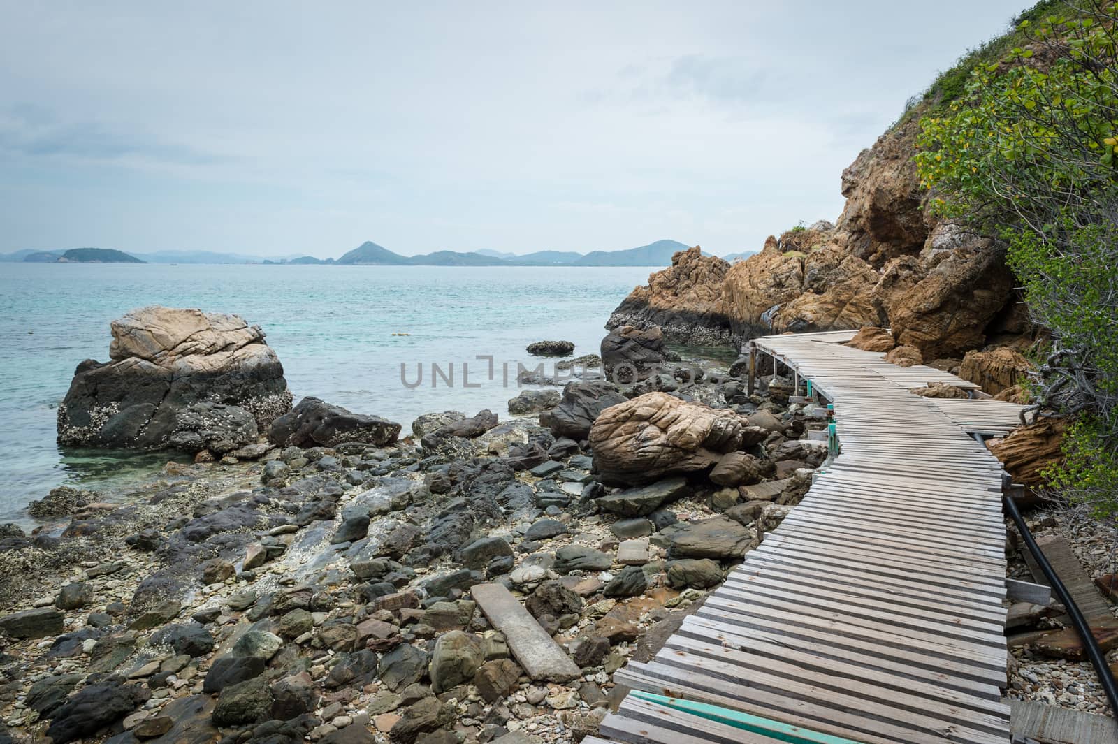 Wooden pathway with rock valley or cliff on the island