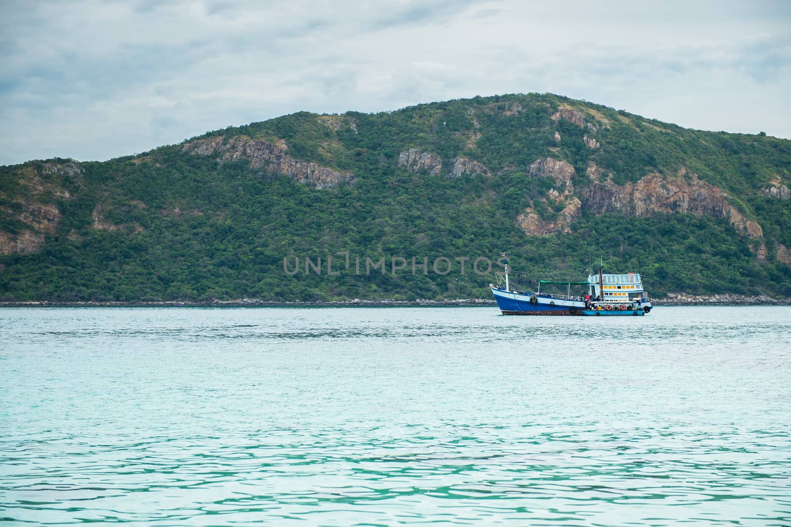 Closeup of boat on the beach with mountain island by sayhmog