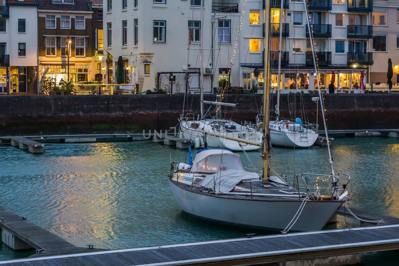 cityscape of the docks of Vlissingen, Decorated boat with lights, popular city in Zeeland at night, the Netherlands