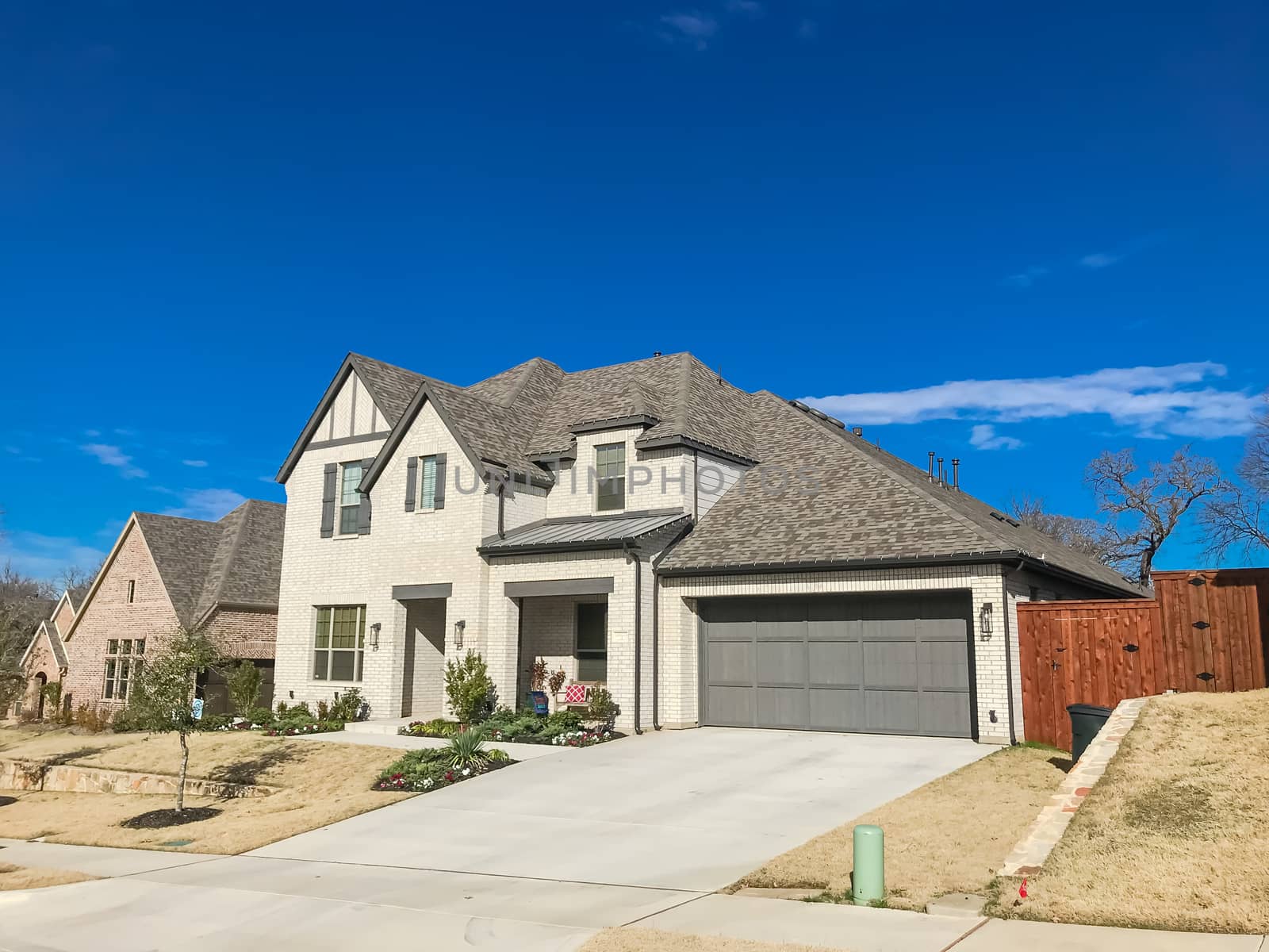 Front porch entrance of newly built 2-story house with attached  by trongnguyen