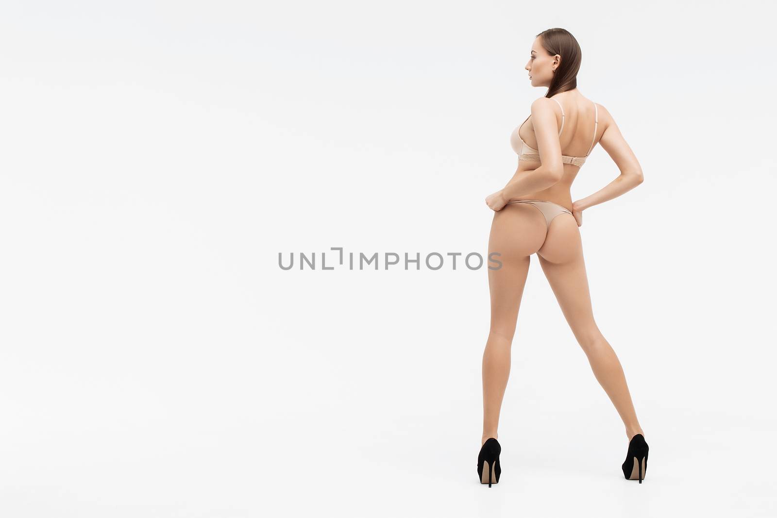 Perfect body young woman on a white background in sexy lingerie