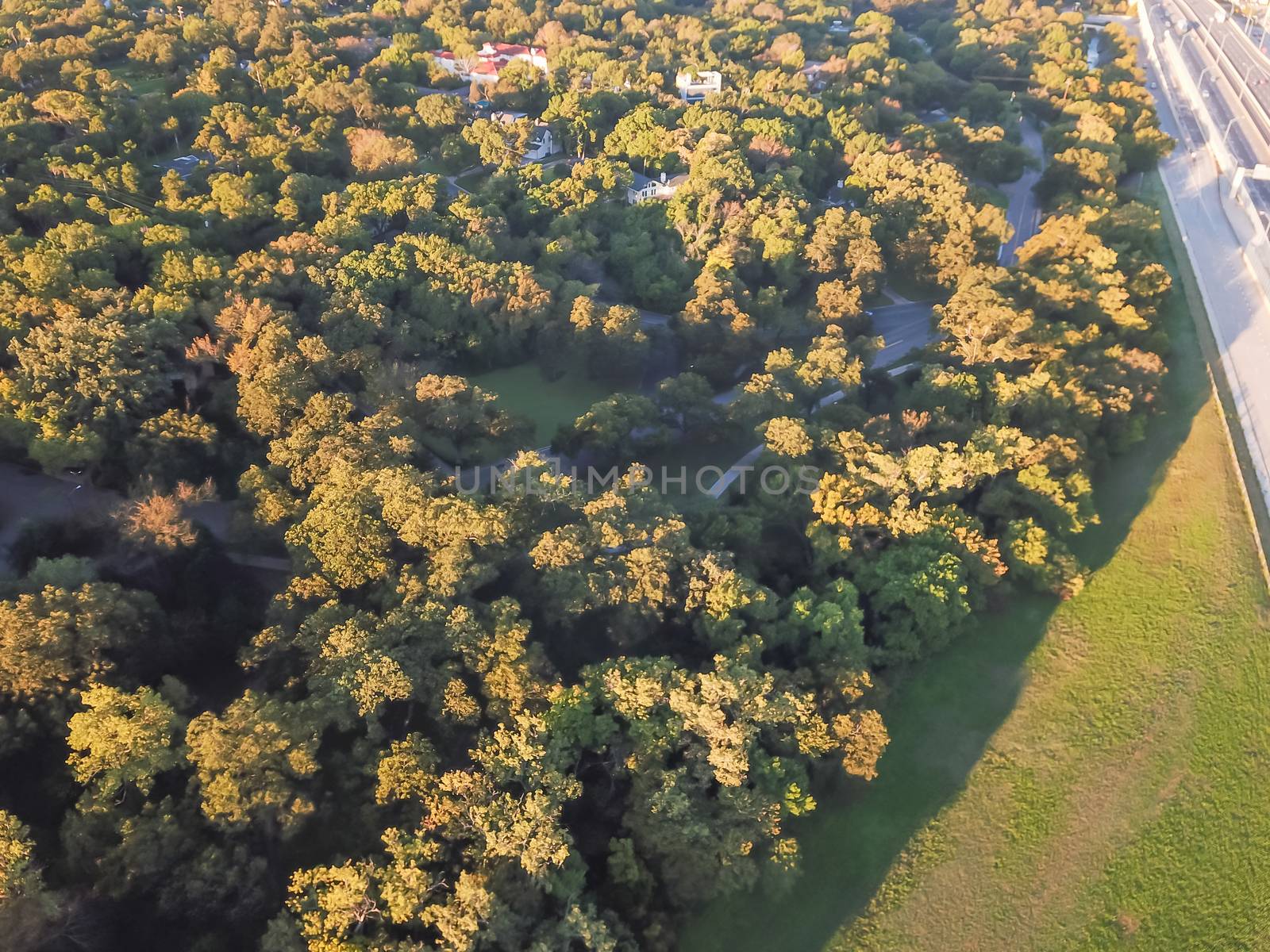 Top view North side of Kessler Park near Highway 30, located just south of downtown Dallas, Texas, USA. Flyover nature area with mature trees and rolling hill terrain