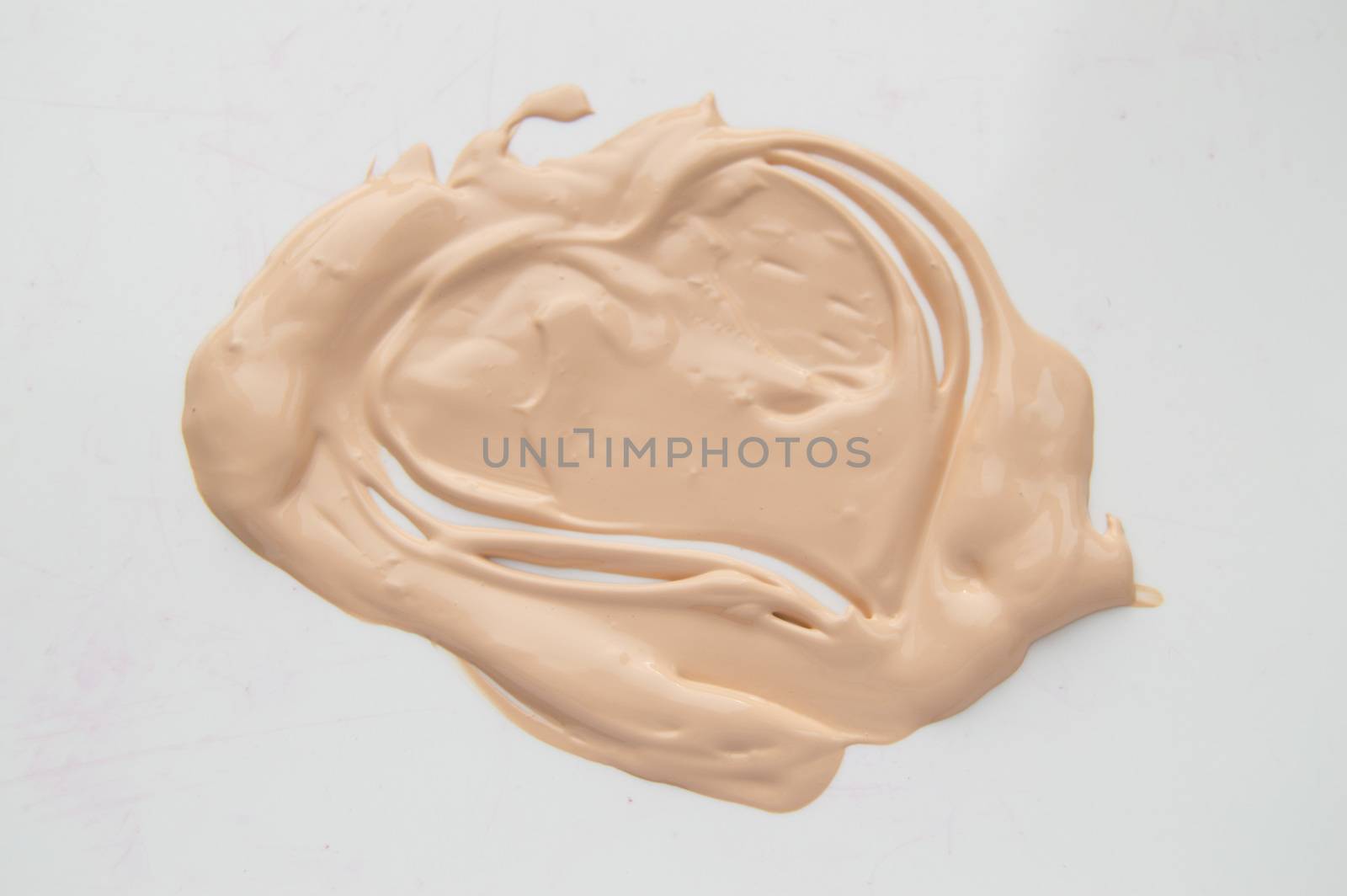 Painted heart, a smear of liquid type Foundation, concealer, white background.
