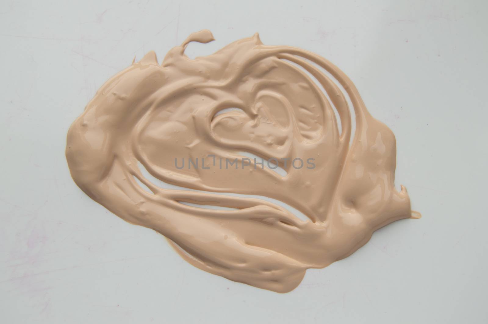 Painted heart, a smear of liquid type Foundation, concealer, white background by claire_lucia