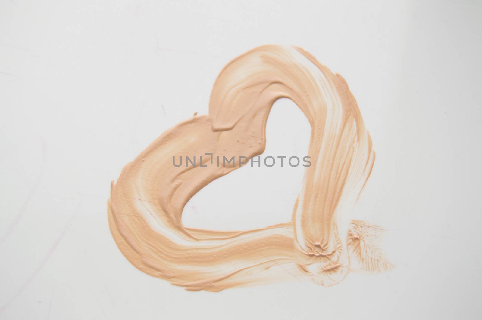 Painted heart, a smear of liquid type Foundation, concealer, white background by claire_lucia
