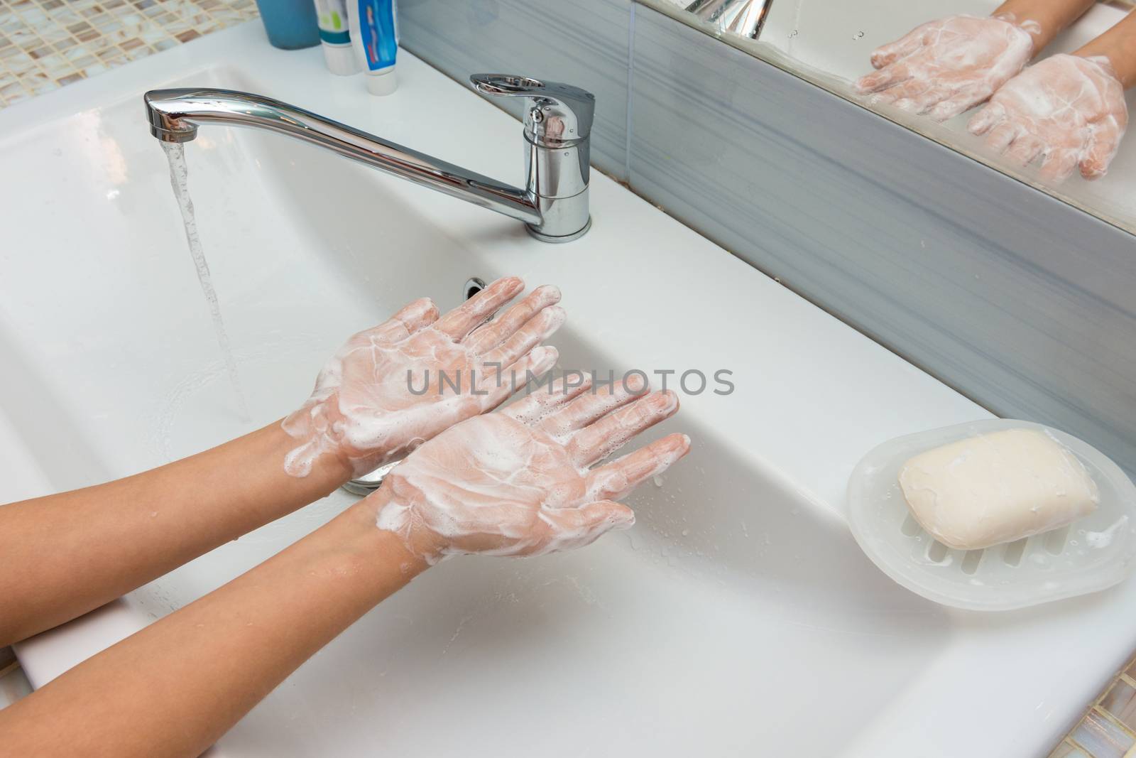 Child shows soaped hands