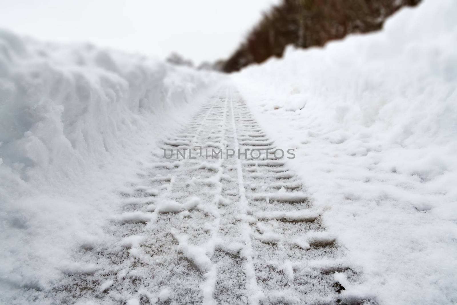 Image of car tracks in white snow by w20er