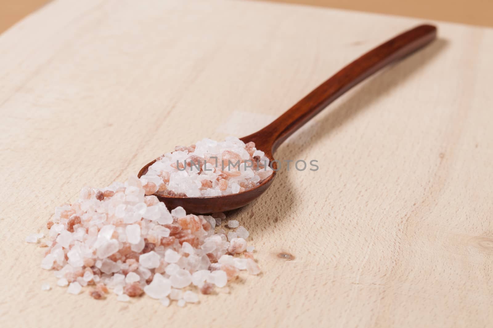 Wood Spoon With Himalayan Salt on Wood Cuttingboard