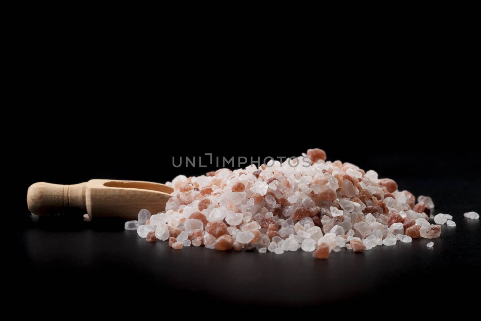 Brown Wood Spice Spoon With Hymalaian Salt Crystals on Black Background