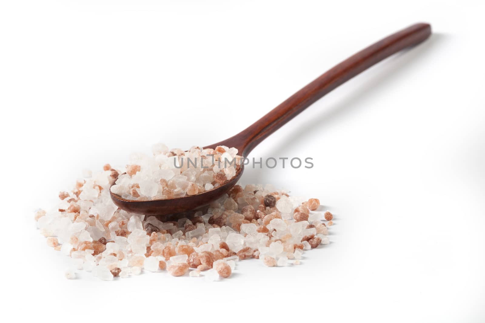 Himalayan Salt Raw Crystals Pile with Brown Wood Spoon Isolated on White Background