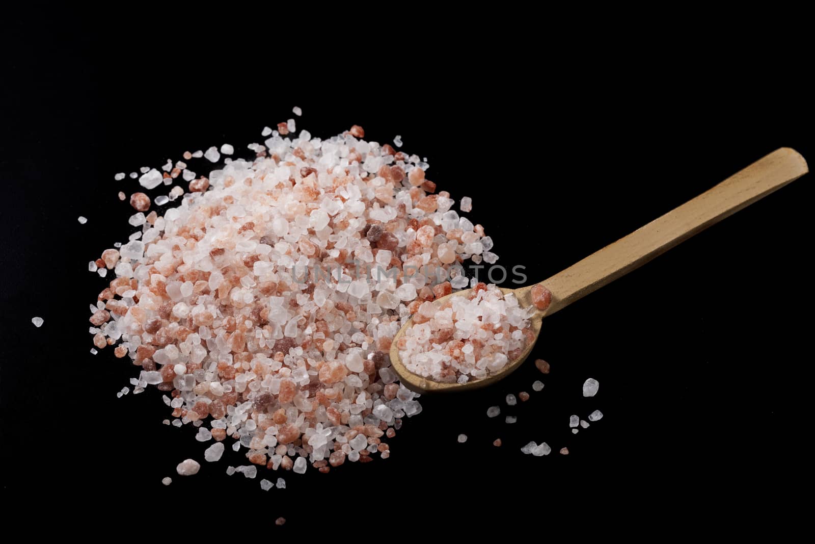 Himalayan Salt Heap With Wood Spoon on Black Background