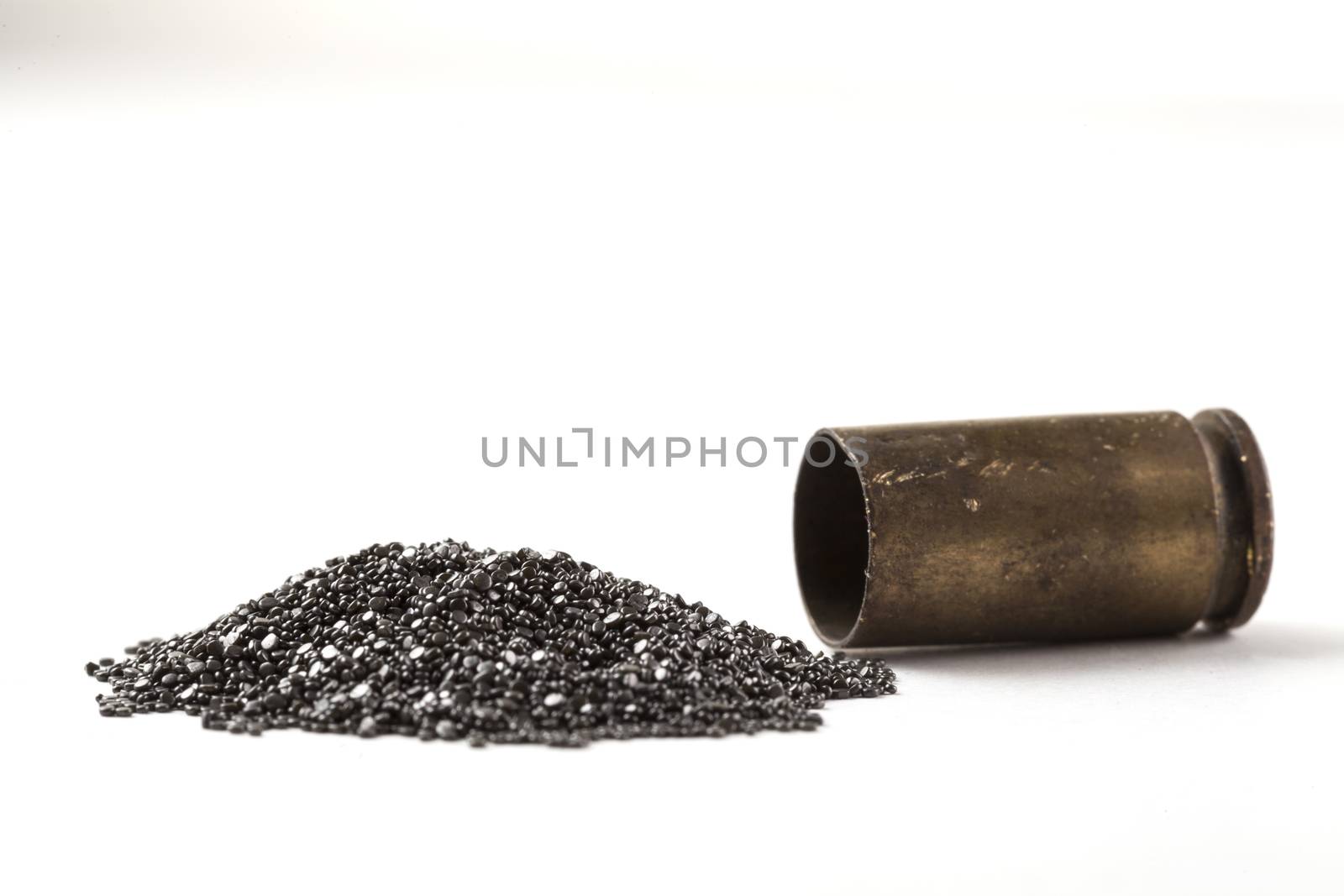 Rifle Bullet and Shel near pile of gunpowder isolated on white